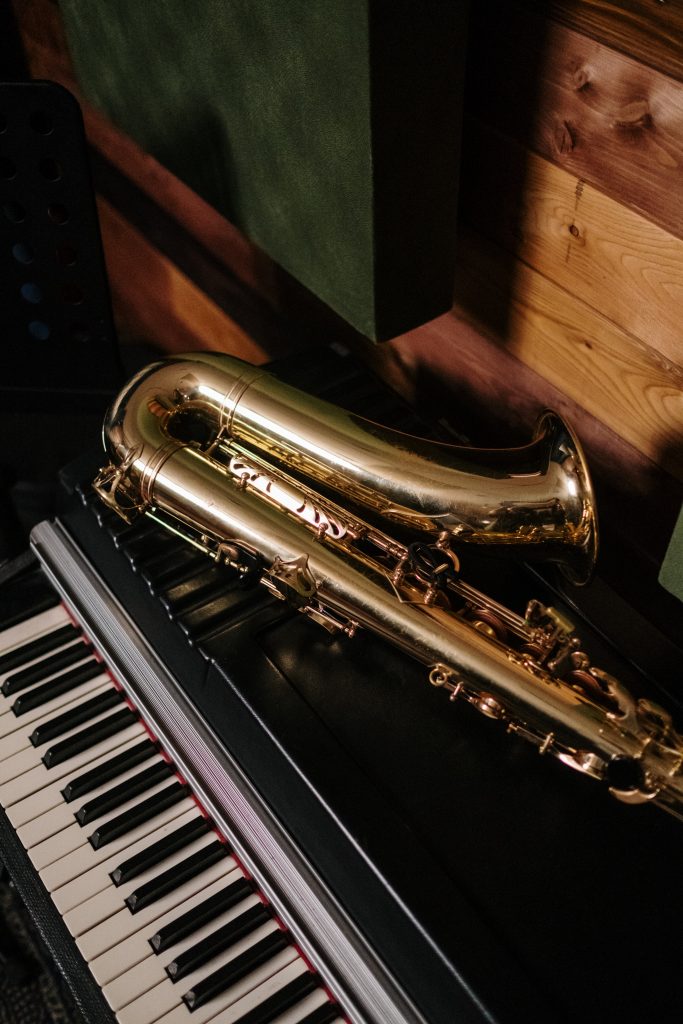 Saxophone lying on top of a piano