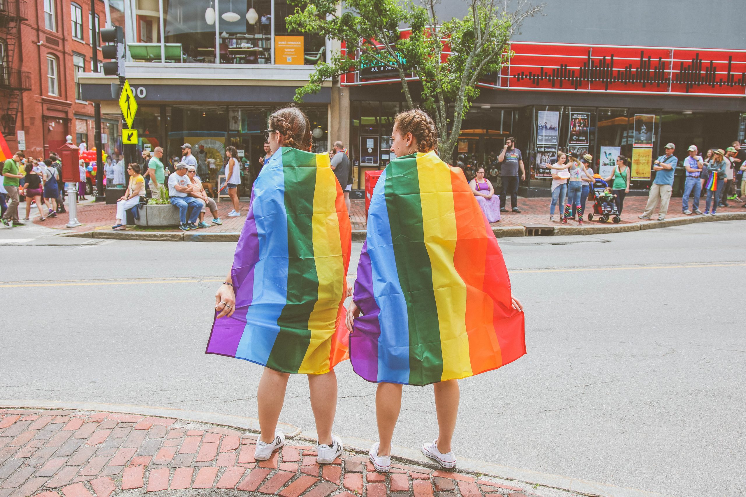 Two people wearing pride flags