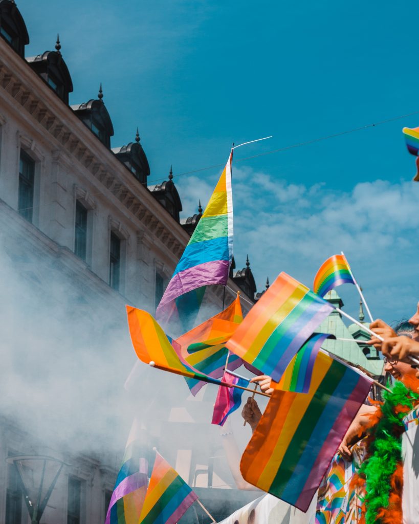 LGBTQ+ pride flags being waved
