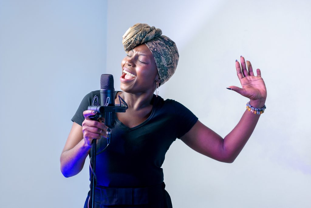 Woman singing into microphone