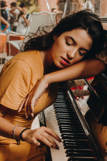 Girl leaning on piano